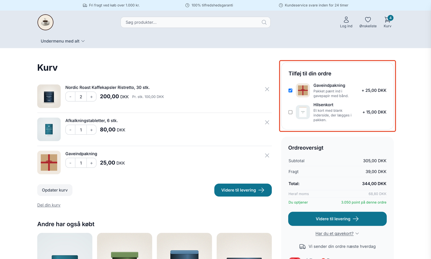 Kurven i temaet Montana med den markerede blok Tilføj til din ordre over ordreoversigten. Tilkøbet Gaveindpakning er afkrydset og ligger i kurven, mens Hilsenkort ikke er afkrydset. Begge viser billede, kort beskrivelse og pris med plus foran